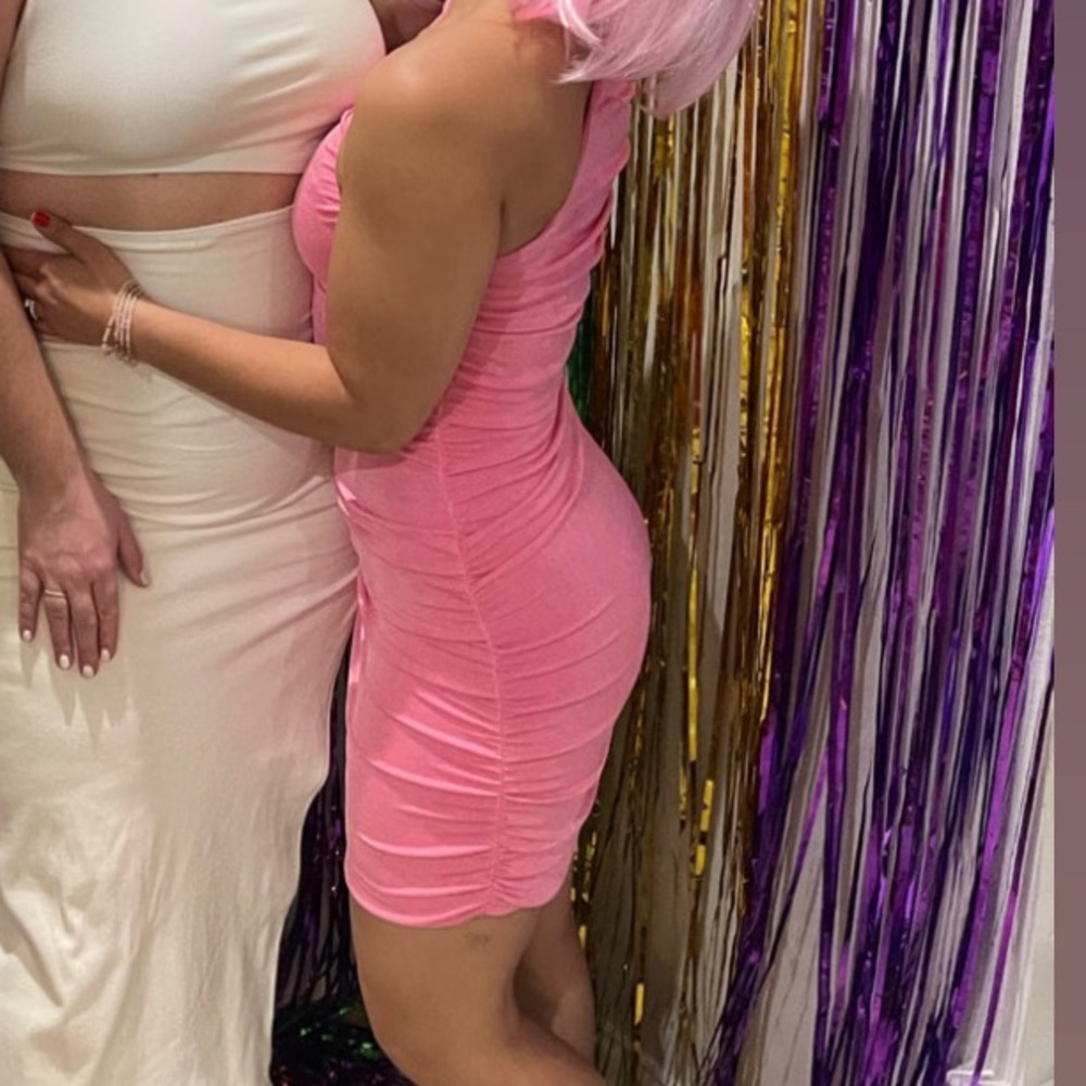 Small, pink one shoulder dress.